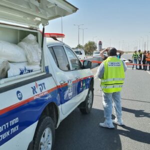 ZAKA emergency vehicle and volunteer on a highway